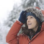 A woman in a parka in the snow